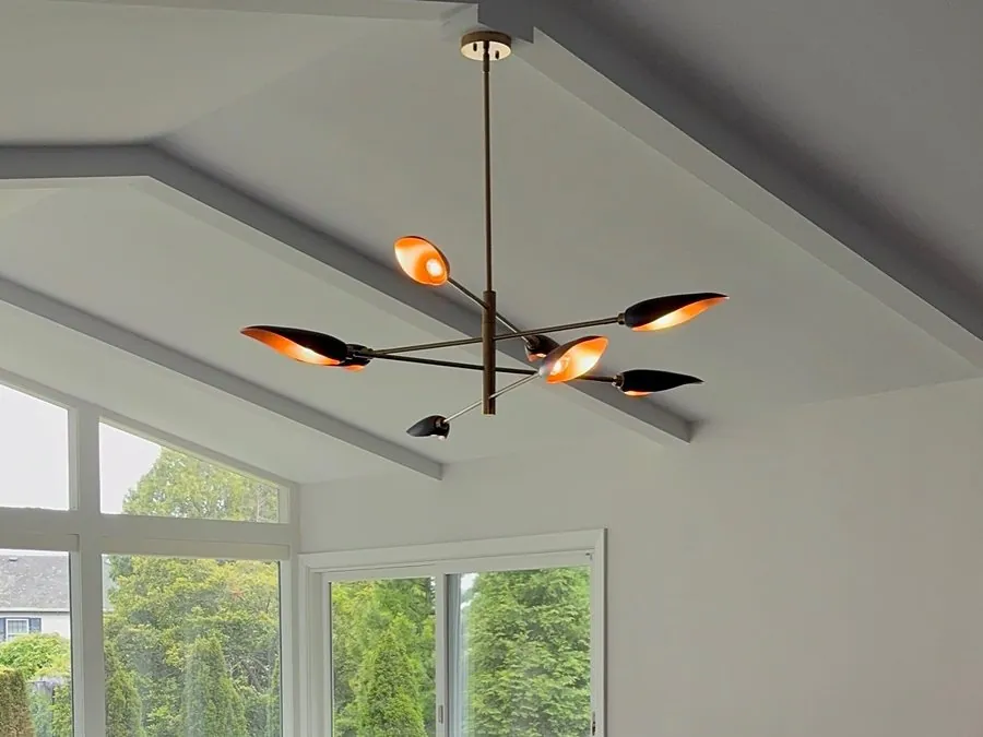 Modern chandelier light fixture installed in a dining room